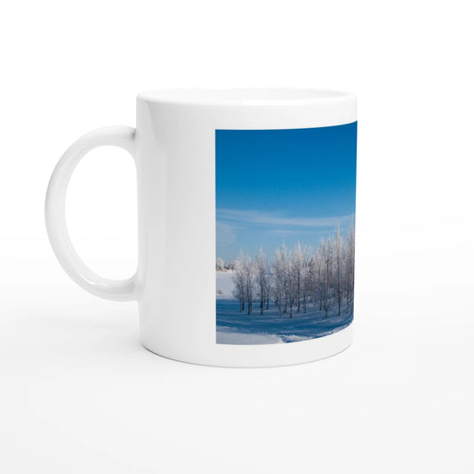 Snowy trees sunrise ceramic mug with winter landscape design